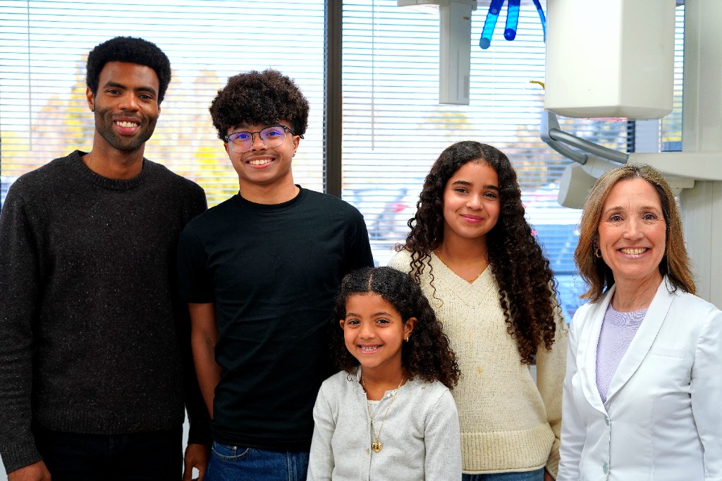 Dr. Michelle Cartier DDS CAGS with smiling Hamptons family